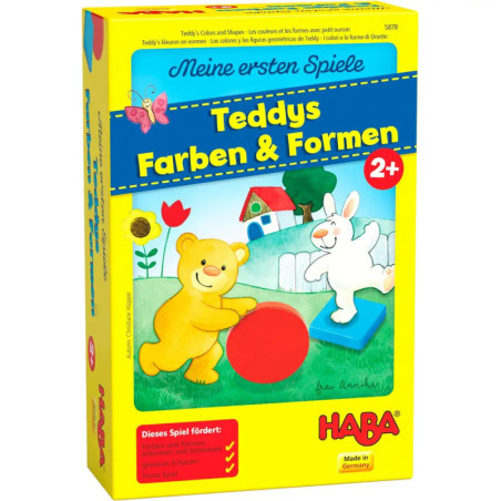 Gelbe Spielschachtel mit Bär und Hase, die auf einer Wiese mit Formen spielen Aufschrift: Teddys Farben & Formen.