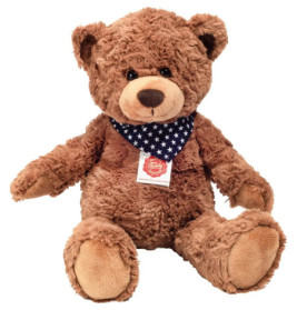 Ein brauner Teddybär mit blauem Halstuch und weißen Sternen sitzt aufrecht und schaut nach vorne.