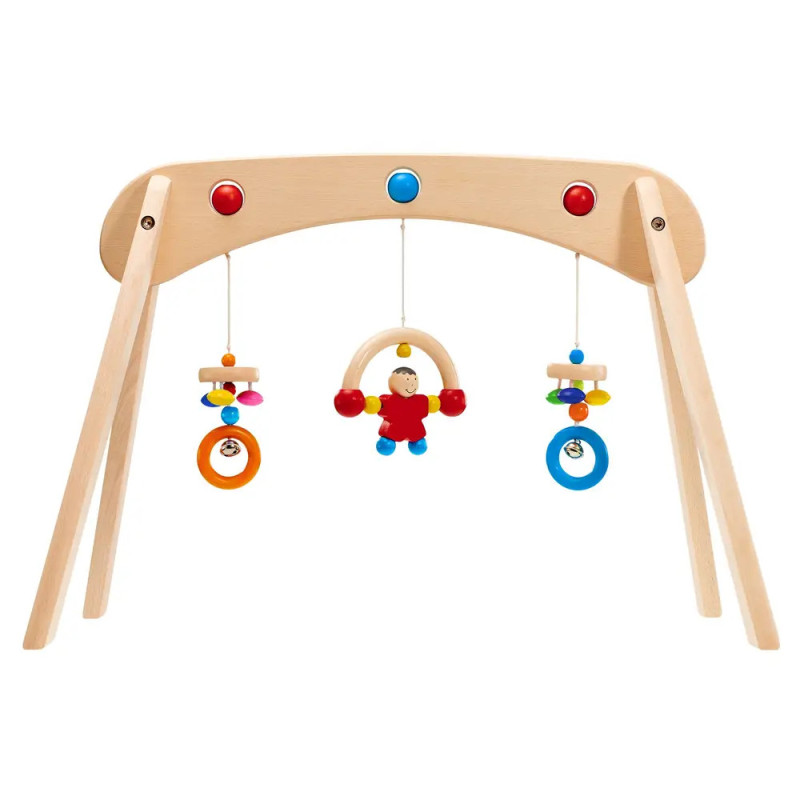 Holz-Spielbogen für Babys mit buntem Spielzeug und einer kleinen Figur in der Mitte. Holz-Spielbogen für Babys mit buntem Spielzeug und einer kleinen Figur in der Mitte.