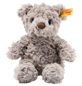 Grauer Teddy mit brauner Nase und gelbem Ohr-Label sitzt aufrecht.