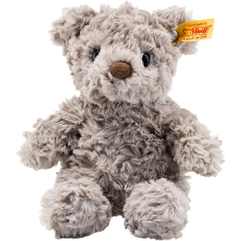 Grauer Teddy mit brauner Nase und gelbem Ohr-Label sitzt aufrecht. Grauer Teddy mit brauner Nase und gelbem Ohr-Label sitzt aufrecht.