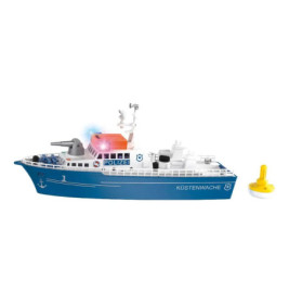 Spielzeug-Küstenwachschiff in Blau-Weiß mit Lichtern und Küstenwache-Aufschrift neben einer kleinen gelben Boje.