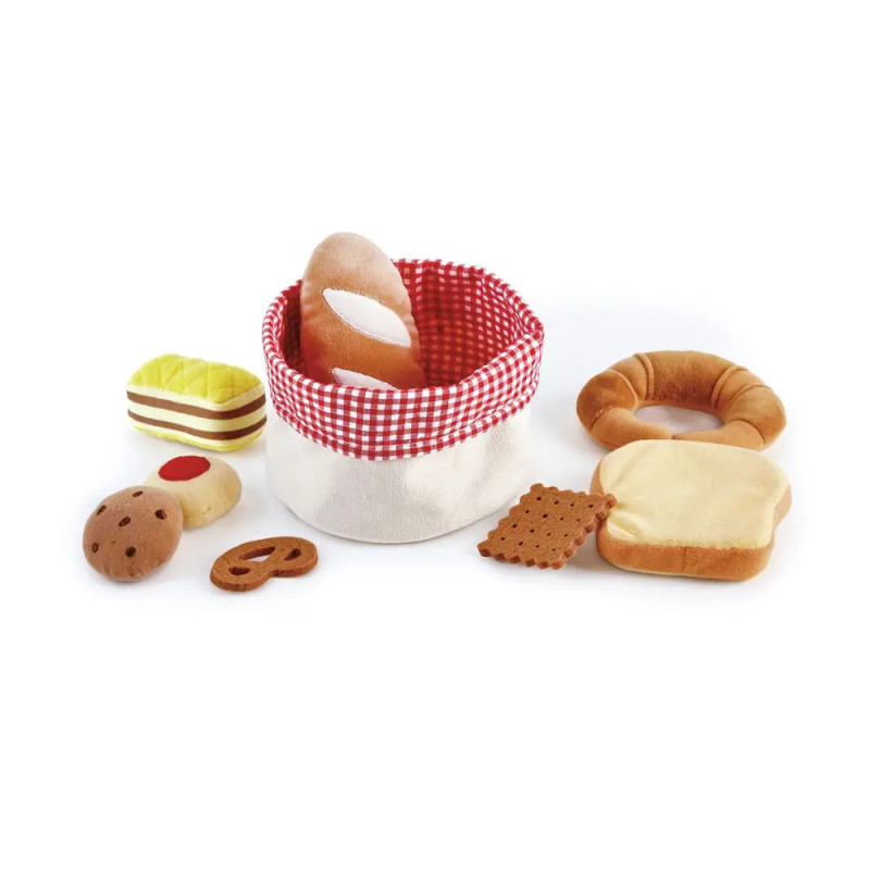 Plüsch-Bäckerei-Set mit Broten, Gebäck und Korb mit rot-kariertem Rand auf weißem Hintergrund. Plüsch-Bäckerei-Set mit Broten, Gebäck und Korb mit rot-kariertem Rand auf weißem Hintergrund.