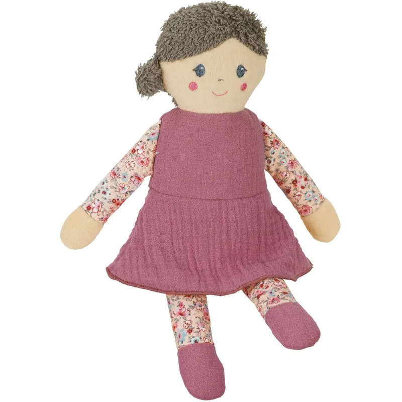 Stoffpuppe mit braunen Haaren, pinkem Kleid und geblümten Armen und Beinen sitzt aufrecht. Stoffpuppe mit braunen Haaren, pinkem Kleid und geblümten Armen und Beinen sitzt aufrecht.