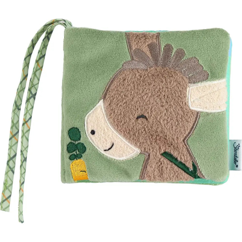 Weiches, grünes Babybuch mit gesticktem Esel, einer Möhre und gemusterten Stoffbändern. Weiches, grünes Babybuch mit gesticktem Esel, einer Möhre und gemusterten Stoffbändern.