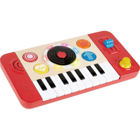 Rotes und weißes Spielzeug-Keyboard mit bunten Tasten, Lautsprecher und Bedienelementen auf rechteckiger Platte. Rotes und weißes Spielzeug-Keyboard mit bunten Tasten, Lautsprecher und Bedienelementen auf rechteckiger Platte.