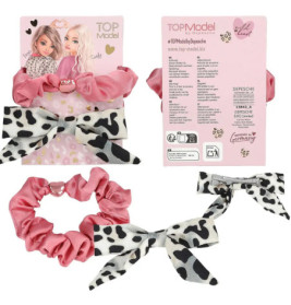 Rosa und Kuhmuster-Haarschmuck von TOPModel mit Verpackung.