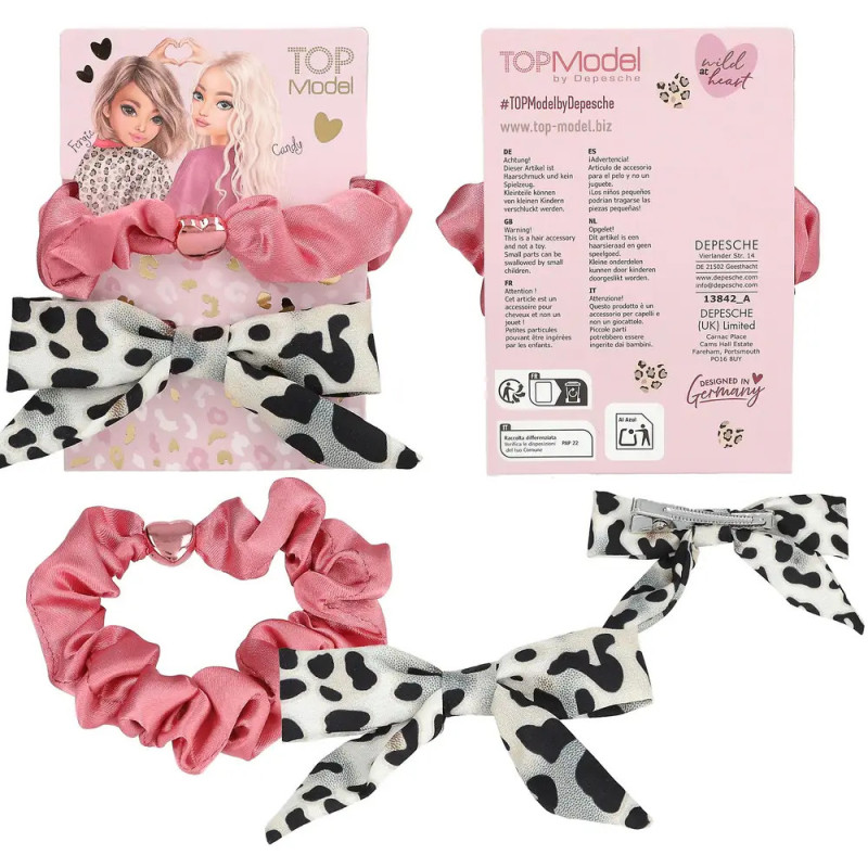 Rosa und Kuhmuster-Haarschmuck von TOPModel mit Verpackung.