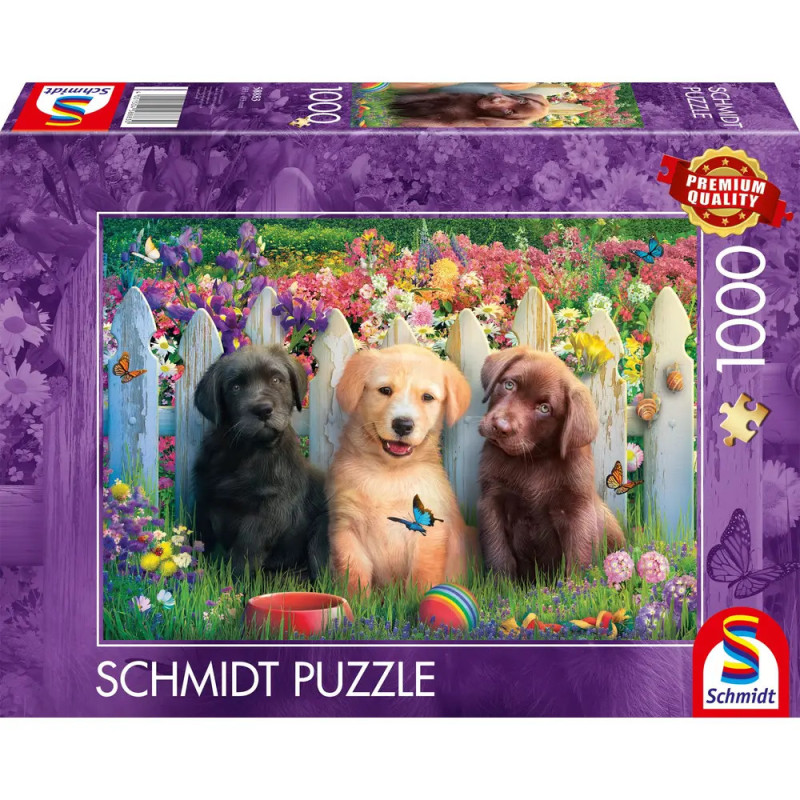 Puzzlebox mit drei Welpen im Gras vor weißem Zaun, dahinter bunte Blumen und Schmetterlinge.