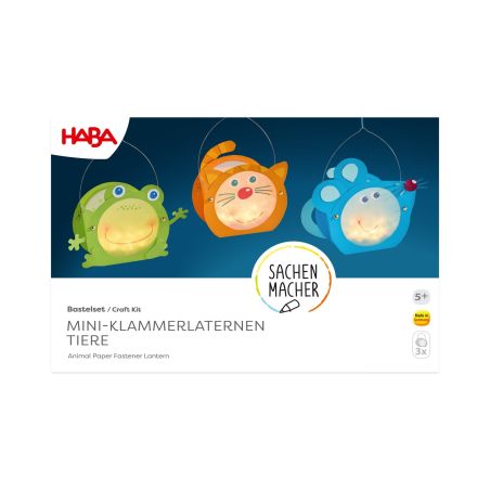 Drei Tier-Laternen (Frosch, Katze, Maus) stehen auf einer weißen Bastelbox von HABA.