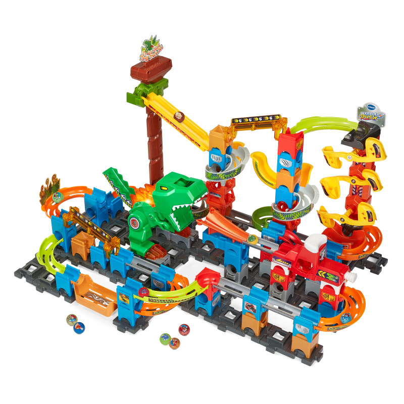Buntes Murmelbahn-Set aus Kunststoff mit Schienen, Rampen, grünem Dinosaurier und Murmeln auf dem Boden.
