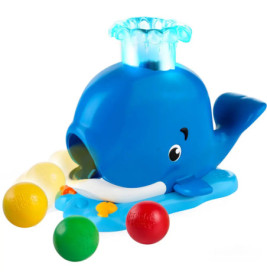 Blaues Wals-Spielzeug mit Wasserspritzern und bunten Bällen davor auf weißem Hintergrund.