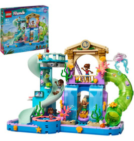 LEGO Friends Wasserpark-Set mit Rutschen, Meeresdeko und vier Minifiguren, Verpackung im Hintergrund.