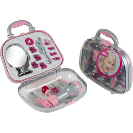 Zwei Spielzeug-Beauty-Sets in Klarsichtboxen mit pink-grauen Styling-Accessoires, Spiegel und Kamm.