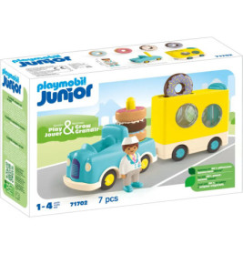 Playmobil Junior Set mit blauem Auto, Gebäckwagen, Fahrerfigur und Donut-Motiv auf der Verpackung.
