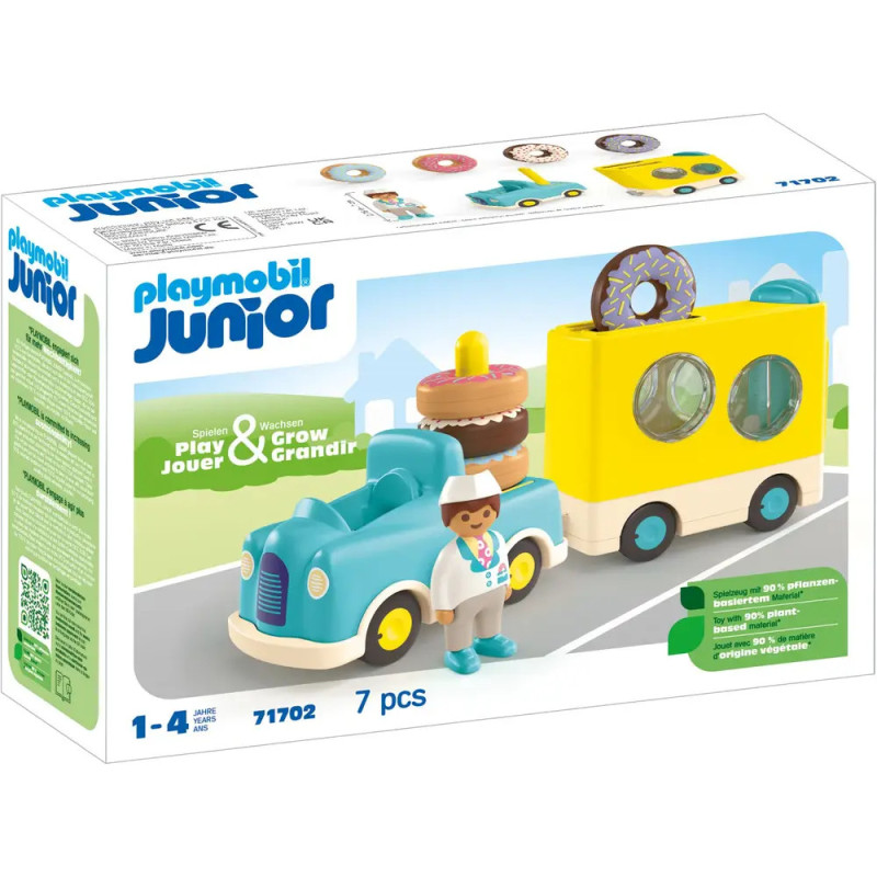 Playmobil Junior Set mit blauem Auto, Gebäckwagen, Fahrerfigur und Donut-Motiv auf der Verpackung.