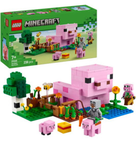 LEGO Minecraft Set mit rosa Schwein, Kleintieren, Minifiguren, Pflanzen und LEGO-Box im Hintergrund.