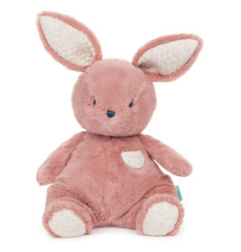 Rosa Plüschhase mit großen Ohren, weißen Akzenten und einer kleinen Bauchtasche.