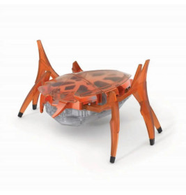 Oranger Spielzeugroboter aus Plastik in Spinnenform mit transparenten Beinen und gemustertem Panzer.