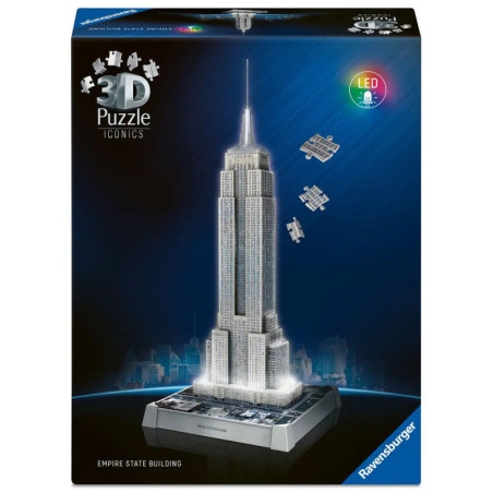 Schachtel des Ravensburger 3D-LED-Puzzles Empire State Building, leuchtend vor blauem Hintergrund.