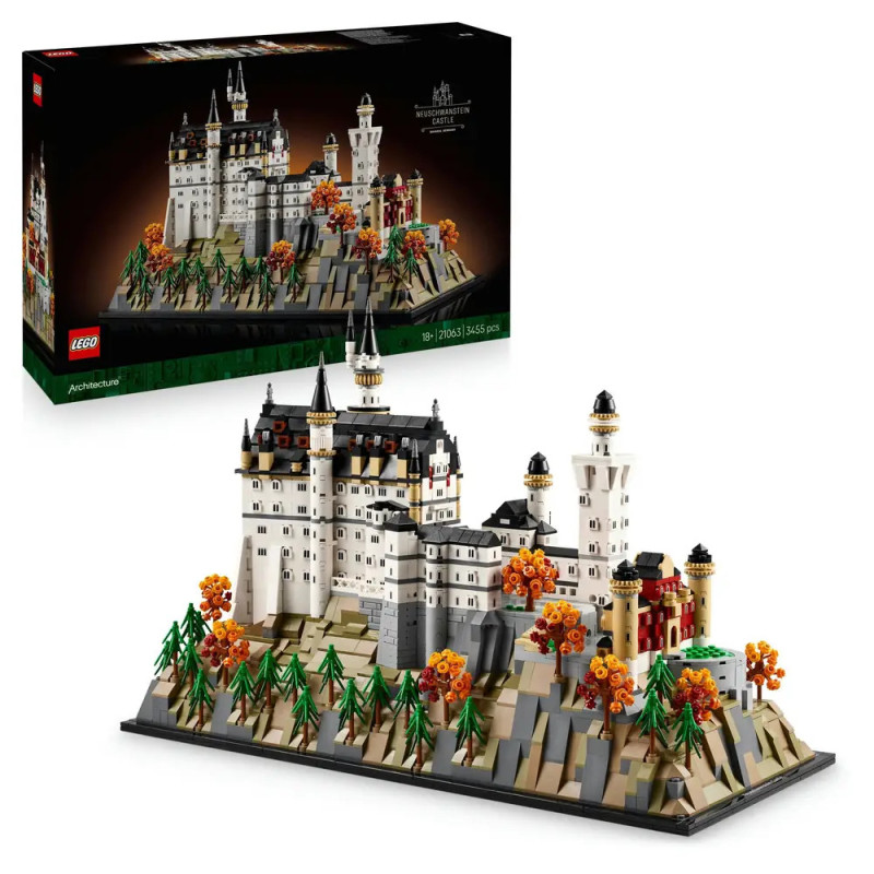 LEGO-Modell einer Burg auf einem Hügel mit Bäumen und Herbstlaub, im Hintergrund die Verpackung.