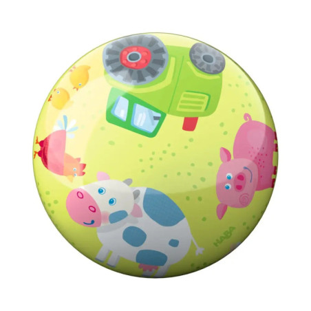 Runder Ball mit Kuh-, Schwein-, Hühner- und grünem Traktor-Motiv auf gelb-grünem Hintergrund.