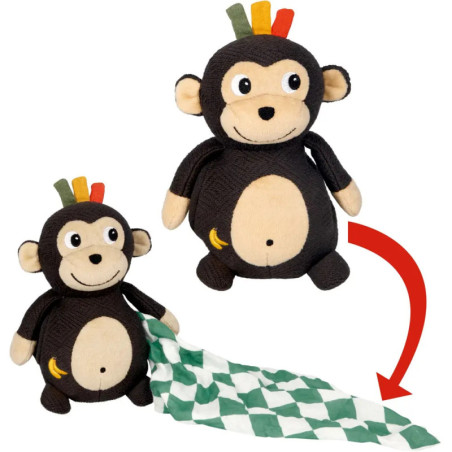 Plüschaffe mit bunten Haarbüscheln zieht eine grün-weiß gemusterte Decke aus seiner Seite.