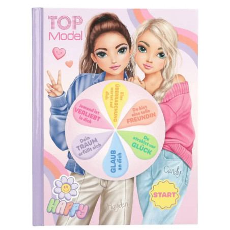 Zwei gezeichnete Mädchen stehen hinter einem bunten Glücksrad auf dem pastellfarbenen TOP Model-Notizbuch.