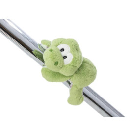 Ein grünes Plüschfrosch-Spielzeug klammert sich schräg an eine glänzende Metallstange.