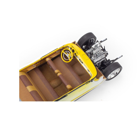 Gelbes Spielzeugauto von oben mit sichtbaren braunen Sitzen, gelbem Lenkrad und freiliegendem Motor.