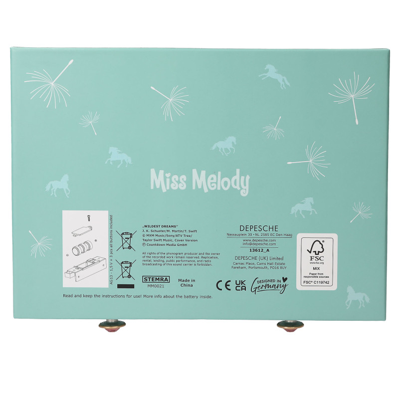 Türkise Miss Melody Box mit weißen Pusteblumen, Pferden und Produktinformationen auf der Rückseite.