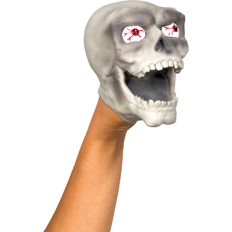 Eine Hand hält eine graue Totenkopf-Puppe mit roten, blutunterlaufenen Augen und offenem Mund.