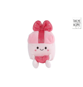 Rosa Plüschfigur als Geschenkbox mit lächelndem Gesicht, Herz in den Händen und rosa Schleife obendrauf.