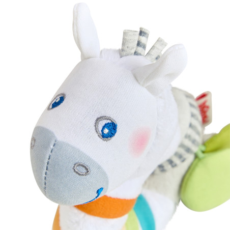 Nahaufnahme eines Plüschzebras mit blauen Augen, grauer Schnauze und bunten Streifendetails.