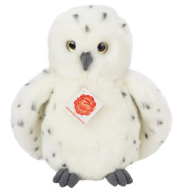 Weiße Schneeeule aus Plüsch mit schwarzen Flecken, gelben Augen und einem Schild auf der Brust.