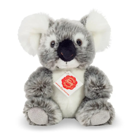 Plüsch-Koala in Grau und Weiß mit Halsband, sitzt aufrecht vor weißem Hintergrund.