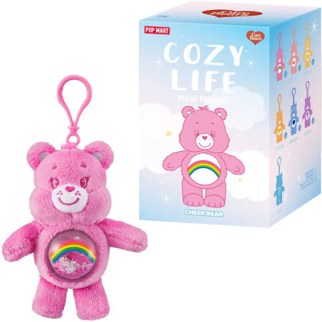 Rosa Care Bear Schlüsselanhänger mit Regenbogenbauch und COZY LIFE Box mit bunten Bärenillustrationen.