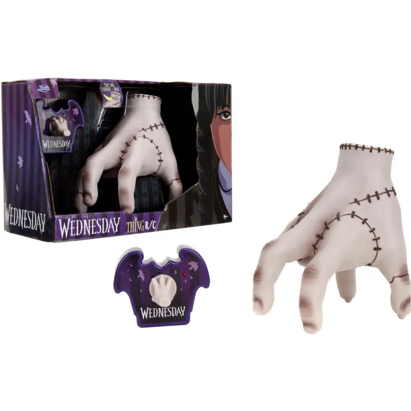 Wednesday Addams Thing Handspielzeug mit Nähten, Box und lila Standfuß mit Wednesday-Aufdruck.