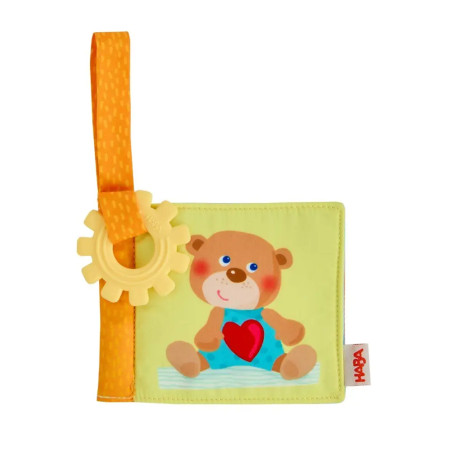 Weiches Babybuch mit Teddybär-Motiv, gelbem Beißring und orangem Befestigungsband.