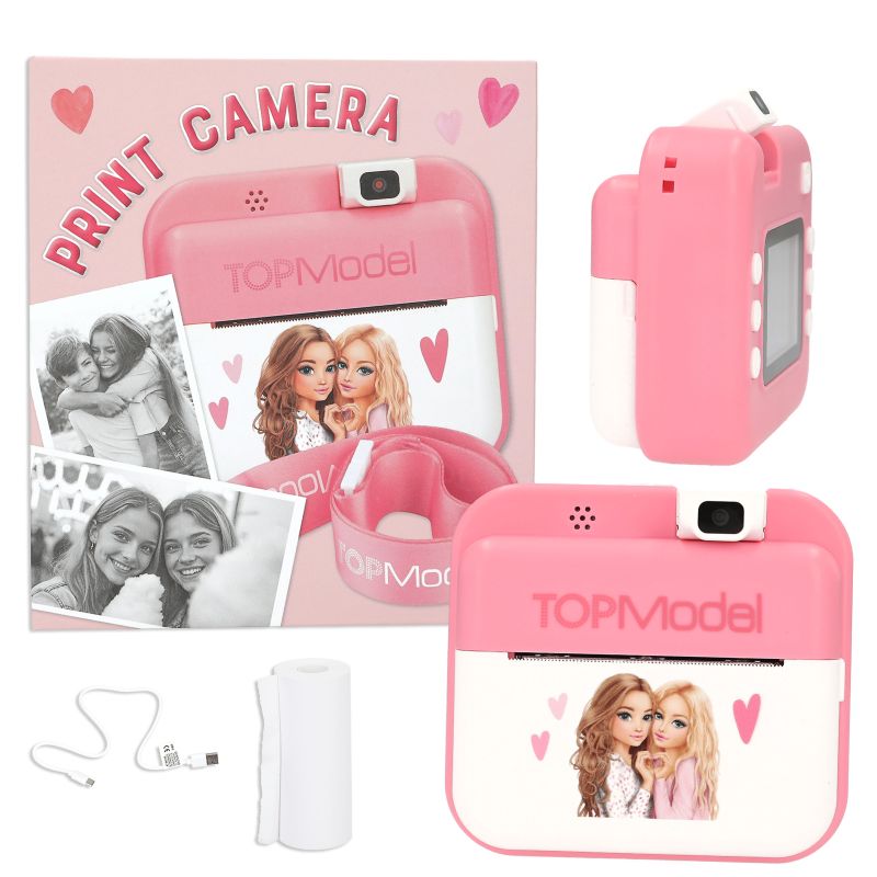 Pinkes Sofortbildkamera-Set mit Fotos, Ladekabel, Ersatzpapier und Mädchen-Motiven auf der Vorderseite.