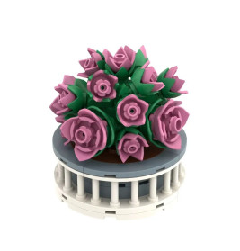 Runde LEGO-Blumendeko mit rosa Blüten und grünen Blättern in einem weißen, runden Topf.