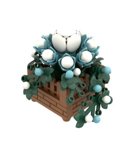 LEGO-Modell weißer und blauer Blumen in braunem Kasten mit grünen Blättern und Ranken.