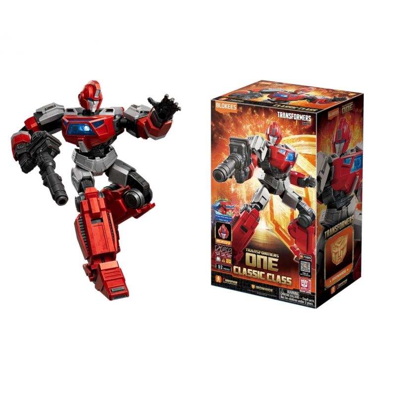 Eine rot-graue Transformers-Figur steht neben ihrer bunten Verpackung.