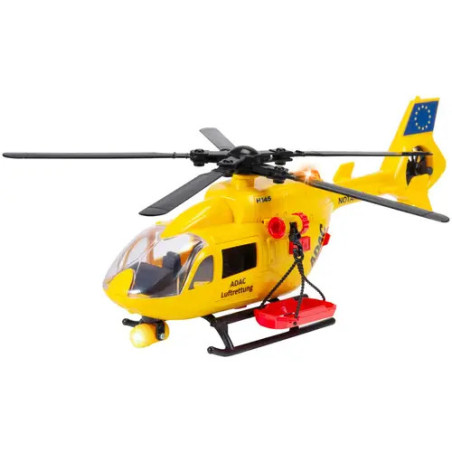 Gelber Spielzeug-Rettungshubschrauber mit schwarzen Rotorblättern und roter Ausrüstung, freigestellt vor weißem Hintergrund.