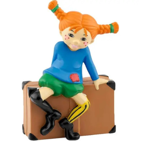 Cartoon-Mädchen mit orangefarbenen Zöpfen sitzt auf einem braunen Koffer und trägt blaues Oberteil und schwarze Stiefel.