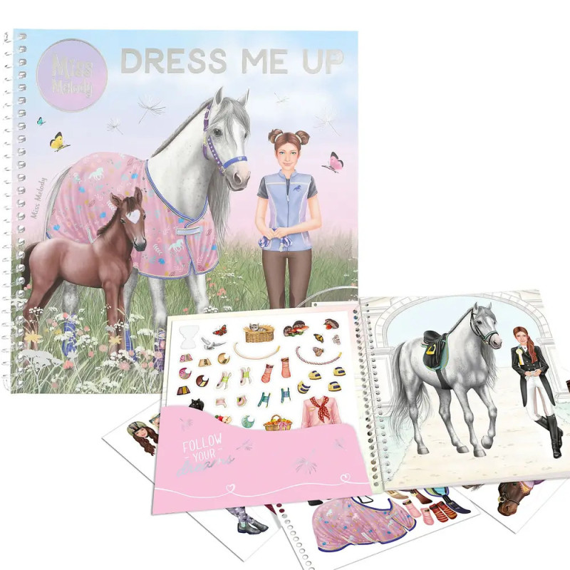 Anziehbücher mit Mädchen, Pferden, Outfits und Accessoires liegen auf weißem Hintergrund.