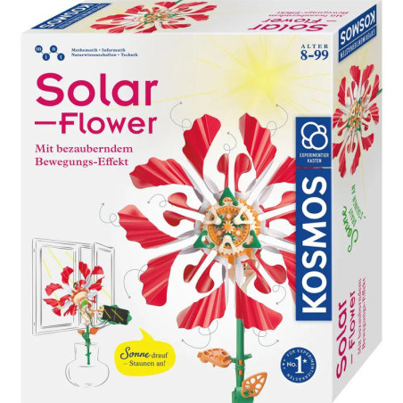 Box eines Kosmos Solar-Flower Sets mit einer rot-rosa mechanischen Blume im Sonnenlicht.