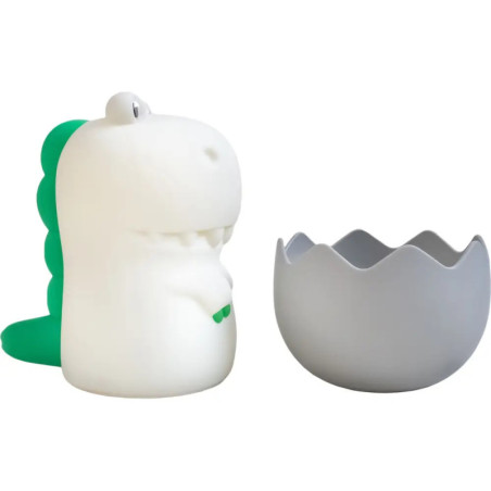 Weiße-grüne Dinosaurierfigur neben grauem, eiförmigem Behälter mit gezacktem Rand.