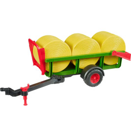 Spielzeug-Farmanhänger mit drei gelben Heuballen, roten und grünen Details.