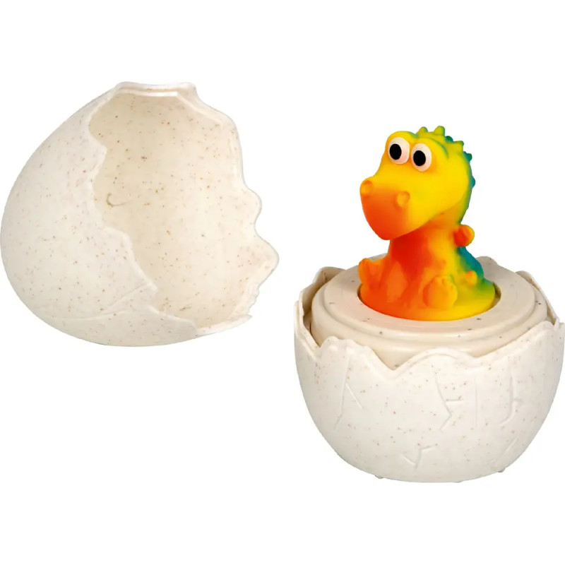 Bunter Spielzeug-Dinosaurier schlüpft aus einem aufgebrochenen weißen Ei, neben ihm liegt ein Teil der Eierschale.